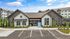 Charming modern apartment complex exterior with beautifully landscaped entrance, offering effortless living.