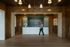 Elegant hotel reception area with wooden walls, stylish chandelier, and modern counter at The Filmont.