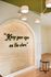 Artistic interior wall design with a motivational quote 'Keep your eyes on the stars', complemented by a modern chandelier and natural wood accents.