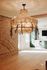 Charming apartment with a stunning chandelier, exposed brick wall, and modern green kitchen cabinets basking in natural light.