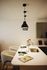 Elegant kitchen with modern pendant lighting, chic bar stools, and a sleek countertop perfect for entertaining.