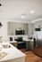 Sleek modern kitchen with stainless steel appliances, elegant grey cabinets, and a spacious quartz countertop.