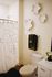 Chic bathroom featuring modern decor, elegant wall art, and stylish shower curtain creating a serene and inviting atmosphere.