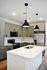 Modern kitchen with stylish pendant lighting, sleek stainless steel appliances, and elegant olive-green cabinetry.