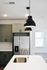 Modern kitchen with sleek pendant lighting, stainless steel appliances, elegant cabinetry, and a polished countertop island with built-in sink.