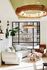 Bright and inviting living room with modern design featuring a cozy white sofa, elegant wooden coffee table, stylish pendant lighting, and lush indoor plant accents.
