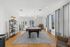 Chic communal lounge featuring a stylish pool table, elegant wooden flooring, and abundant natural light from large windows.