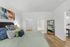 Modern bedroom with elegant decor, featuring a luxurious bed, hardwood floors, and a spacious walk-in closet with an adjacent bathroom.