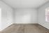 Bright and spacious empty room with plush carpet and ample natural light through the window, perfect for customization.