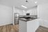 Modern kitchen with sleek stainless steel appliances, spacious countertops, and elegant hardwood floors.