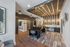 Modern communal workspace featuring stylish wood accents, cozy seating, and ambient lighting.