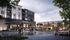 Vibrant mixed-use development showcasing modern apartments above a lively retail space, surrounded by lush greenery and bustling pedestrians.