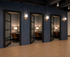 Elegant office space with stylish private booths, featuring chic lighting and comfortable seating, ideal for productive work sessions.