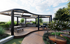 Elegant rooftop terrace with modern pergola, sleek BBQ grills, and lush greenery, perfect for outdoor entertaining.