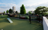 Beautiful rooftop garden with lush greenery, open space, and skyline views perfect for relaxation and outdoor activities.