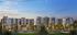 Luxurious modern apartment complex with elegant architecture, surrounded by lush greenery and illuminated against a stunning twilight sky.