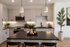Modern kitchen with sleek countertops, stylish cabinetry, and elegant lighting, featuring a central island with decorative accents.