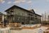 Modern apartment complex with spacious balconies, luxurious outdoor pool, and inviting fire pit area.