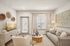 Elegant living room with cozy seating, modern decor, and natural light, creating a warm and inviting atmosphere.