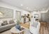 Modern open-concept living room and kitchen with elegant decor, featuring a cozy seating area, chic artwork, and a sleek white kitchen with stainless steel appliances.