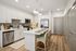 Modern kitchen with elegant white cabinetry, stainless steel appliances, and a stylish island with seating.