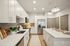 Modern kitchen with sleek white cabinets, stainless steel appliances, and a spacious island with elegant pendant lighting.