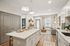 Elegant modern apartment interior featuring a sleek kitchen island, stylish living area, and cozy decor with warm natural light.