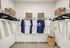 Spacious, well-organized walk-in closet with ample shelving and hanging space, featuring neatly arranged clothes and stylish wicker baskets.