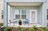 Charming covered patio featuring sleek outdoor furniture, perfect for relaxing and enjoying a cozy outdoor space.