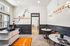 Chic coffee corner with modern design, inspirational 'Dare to be Bold' mural, and elegant lighting in Trapeze Cafe.