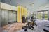 Bright and modern fitness center with state-of-the-art gym equipment, vibrant decor, and ample natural lighting.
