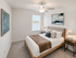 Bright and cozy bedroom with contemporary decor, featuring a plush bed, elegant artwork, and natural light streaming through the window.