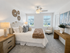 Charming bedroom with plush decor, featuring a cozy bed, elegant side tables, and soft lighting in a bright space.