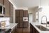 Modern kitchen featuring elegant cabinetry, sleek countertops, and contemporary lighting, exuding a cozy and inviting atmosphere.