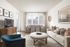 Bright and inviting living room with modern decor, featuring a comfortable beige sofa, stylish round coffee table, and a chic dining area with elegant chairs.