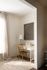 Cozy and elegant home office nook with a stylish wooden desk, classic chair, soft lighting, and tasteful artwork.