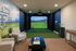 Luxurious home golf simulator room with sleek seating, vibrant wall art, and modern decor, perfect for sports enthusiasts.