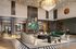 Luxurious modern living room featuring elegant marble accents, a grand chandelier, and stylish contemporary furniture.