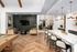 Elegant apartment lounge area with a pool table, cozy seating, chic lighting, and a modern kitchen bar with stylish stools.