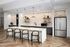 Elegant modern kitchen with a sleek marble island, patterned backsplash, and stylish pendant lighting.