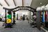 Modern gym interior featuring state-of-the-art equipment, vibrant weight plates, and a sleek design offering an invigorating workout experience.