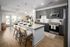 Modern open-concept kitchen and living area featuring sleek dark cabinets, granite countertops, and stylish bar seating under elegant pendant lighting.