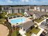 Luxurious apartment complex with beautiful outdoor pool, landscaped grounds, and spacious modern living spaces.