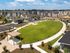 Modern apartment community with expansive green spaces, elegant buildings, and convenient parking, offering a serene living environment.