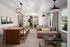 Chic and contemporary living room with ample natural light, featuring a cozy sectional sofa, stylish dining table with modern chairs, and elegant pendant lighting.