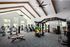 Modern, well-lit gym with state-of-the-art exercise equipment and sleek, open design.