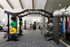 Modern fitness center with diverse weightlifting and exercise equipment, complemented by natural light and stylish design elements.
