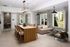 Elegant open-concept dining and living area featuring a modern wooden table, cozy beige sofa, large windows with stylish curtains, and comforting natural light.