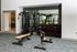 Modern apartment gym featuring top-of-the-line fitness equipment, mirrors, and ample space for an invigorating workout.