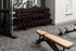 Modern fitness room featuring a variety of free weights, sleek exercise equipment, and comfortable seating for an invigorating workout experience.